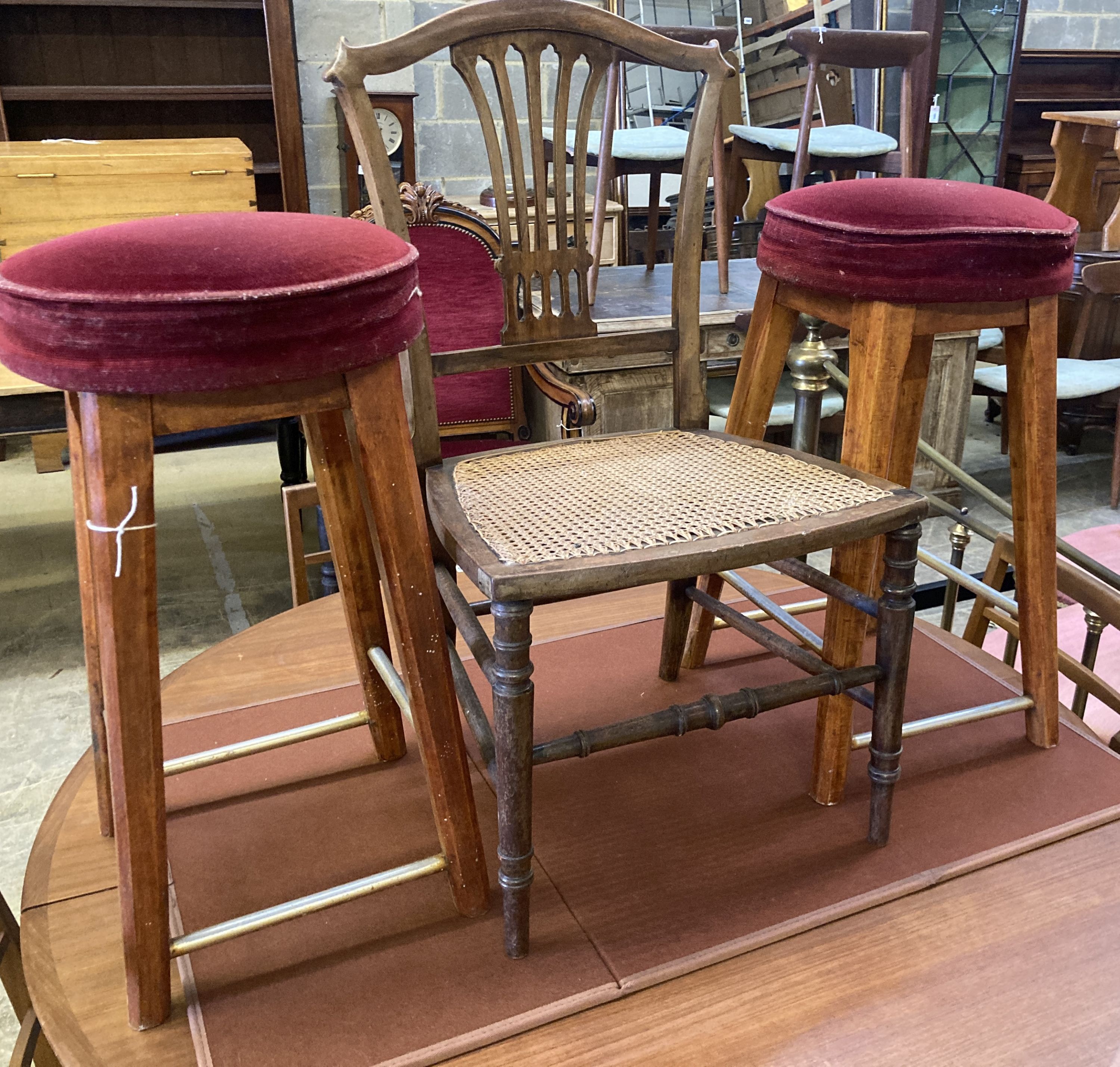 An Edwardian cane seat chair and a pair of beech stools